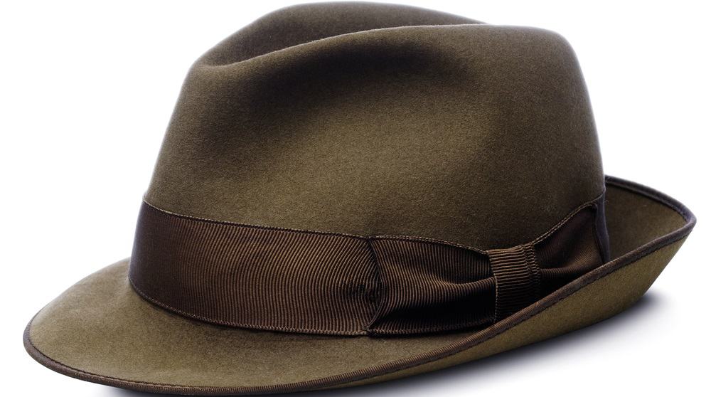 A close look at a brown homburg hat with a darker brown band.