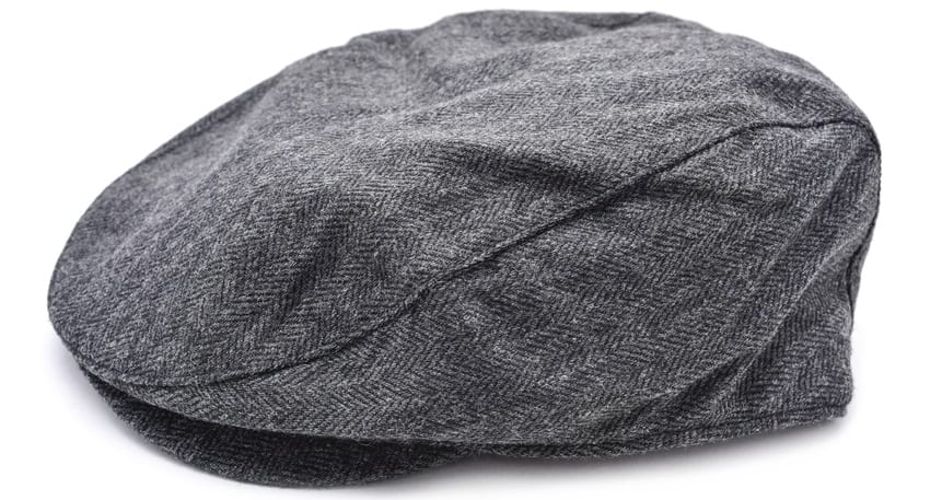 This is a close look at a gray cloth ivy cap on a white surface.