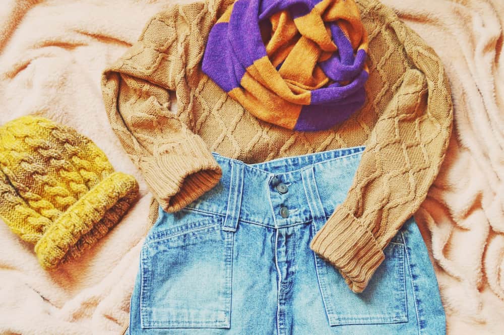 This is a prepared outfit of the day with a denim skirt and a brown sweater.